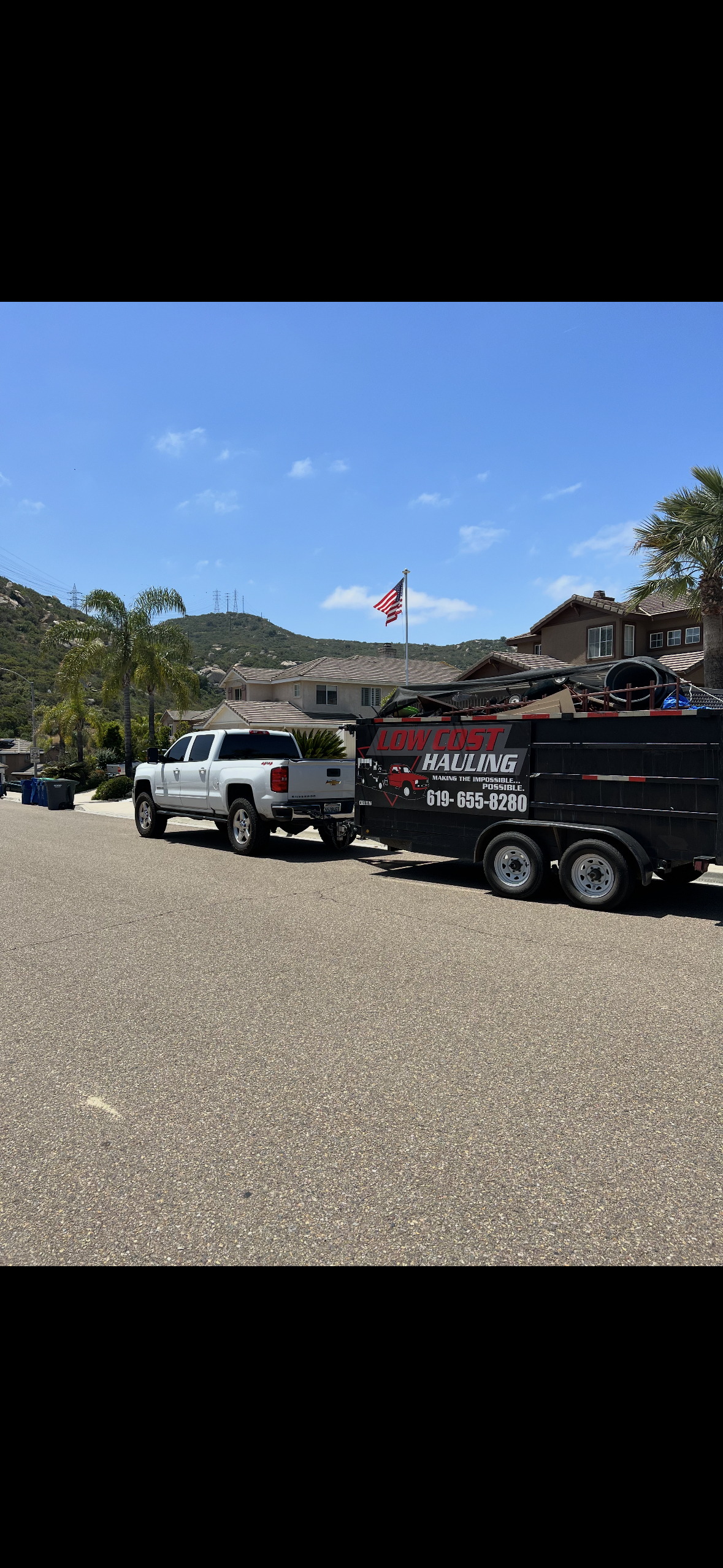 Low Cost Hauling truck pulling loaded trailer in San Diego residential neighborhood